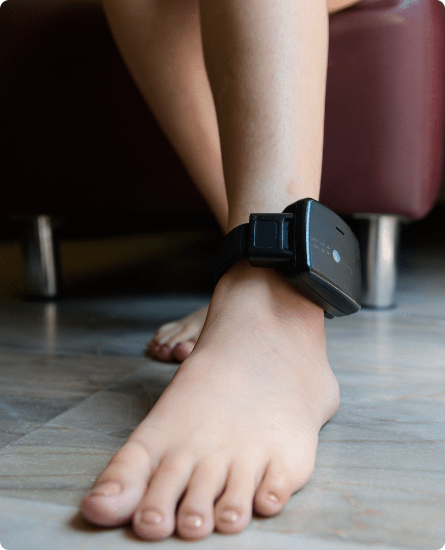 Person wearing an ankle bracelet